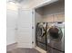 Convenient laundry area with modern washer and dryer, shelving, and ample space at 3417 Cardinal Lake Dr, Durham, NC 27704