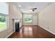 Bright living room with a cozy fireplace, hardwood floors, large windows, and a ceiling fan at 3417 Cardinal Lake Dr, Durham, NC 27704