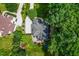 Aerial view showcasing the home's roof, patio, surrounding landscape, and driveway at 3748 Westbury Lake Dr, Raleigh, NC 27603