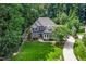 Aerial view of home with a long driveway and lush green lawn surrounded by mature trees at 3748 Westbury Lake Dr, Raleigh, NC 27603