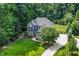 Aerial view of home with a long driveway and lush green lawn surrounded by mature trees at 3748 Westbury Lake Dr, Raleigh, NC 27603