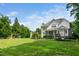 Spacious backyard with lush green grass, mature trees, and outdoor play equipment at 3748 Westbury Lake Dr, Raleigh, NC 27603