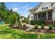 Beautifully landscaped backyard with a lush lawn, patio, and mature trees at 3748 Westbury Lake Dr, Raleigh, NC 27603