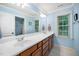 Bathroom featuring double sinks with wood cabinets and a large mirror at 3748 Westbury Lake Dr, Raleigh, NC 27603