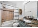 Bathroom featuring a tub/shower combination with updated tile work and granite countertops at 3748 Westbury Lake Dr, Raleigh, NC 27603
