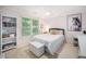 Cozy bedroom featuring soft pink walls, a window view, and stylish decor at 3748 Westbury Lake Dr, Raleigh, NC 27603
