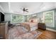 Spacious primary bedroom boasting a tray ceiling, hardwood floors, and lots of natural light at 3748 Westbury Lake Dr, Raleigh, NC 27603