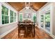 Bright dining room featuring hardwood floors, a vaulted ceiling, a fireplace, and access to outdoor space at 3748 Westbury Lake Dr, Raleigh, NC 27603