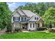 Charming two-story home featuring manicured lawn, brick and siding, and mature trees on a sunny day at 3748 Westbury Lake Dr, Raleigh, NC 27603