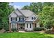 Charming two-story home featuring manicured lawn, brick and siding, and mature trees on a sunny day at 3748 Westbury Lake Dr, Raleigh, NC 27603