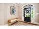 Elegant foyer featuring a beautiful door, a cushioned bench, and a decorative mirror at 3748 Westbury Lake Dr, Raleigh, NC 27603