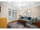 Cozy living room featuring hardwood floors, a neutral palette, and natural light from large windows at 3748 Westbury Lake Dr, Raleigh, NC 27603