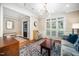 Cozy living room featuring hardwood floors, a neutral palette, and natural light from large windows at 3748 Westbury Lake Dr, Raleigh, NC 27603
