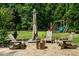 Outdoor patio area with comfortable seating, a fire pit, and lush greenery at 3748 Westbury Lake Dr, Raleigh, NC 27603