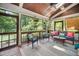 Relaxing screened porch with wicker furniture, a ceiling fan, and scenic views at 3748 Westbury Lake Dr, Raleigh, NC 27603