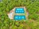 Aerial view of community tennis and basketball courts surrounded by lush green trees at 39 Westover Ct, Sanford, NC 27332
