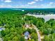 Scenic aerial view of homes nestled among lush greenery near a tranquil lake, a nature lover's paradise at 39 Westover Ct, Sanford, NC 27332