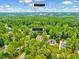 A serene aerial view showcasing a lush, wooded neighborhood, perfect for peaceful living at 39 Westover Ct, Sanford, NC 27332