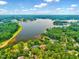 Breathtaking aerial view of a scenic lake surrounded by lush green trees and charming homes at 39 Westover Ct, Sanford, NC 27332