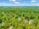 A serene aerial view showcasing a lush, wooded neighborhood, perfect for peaceful living at 39 Westover Ct, Sanford, NC 27332