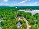 Scenic aerial view of homes nestled among lush greenery near a tranquil lake, a nature lover's paradise at 39 Westover Ct, Sanford, NC 27332