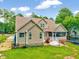 Landscaped backyard with patio, trampoline, and lush trees at 39 Westover Ct, Sanford, NC 27332