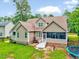 Landscaped backyard with patio, trampoline, and lush trees at 39 Westover Ct, Sanford, NC 27332