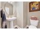 Powder room featuring a pedestal sink and neutral decor with elegant Sunflower painting at 39 Westover Ct, Sanford, NC 27332