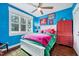 Bright and cheerful bedroom featuring colorful decor and a large window at 39 Westover Ct, Sanford, NC 27332