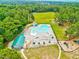 Aerial view of a community pool with lounge chairs, a playground, and mature trees at 39 Westover Ct, Sanford, NC 27332