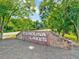 Welcoming entrance sign to Carolina Lakes, featuring stone accents and lush landscaping at 39 Westover Ct, Sanford, NC 27332