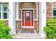 Inviting front entrance with a red door, stone accents, and decorative lighting at 39 Westover Ct, Sanford, NC 27332
