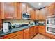 Well-equipped kitchen featuring granite countertops, stainless steel appliances, and wooden cabinetry at 39 Westover Ct, Sanford, NC 27332