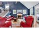 This living room features high ceilings, fireplace, and comfortable seating on hardwood floors at 39 Westover Ct, Sanford, NC 27332