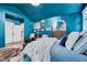 A primary bedroom with striking blue walls, decor, and plush bedding at 39 Westover Ct, Sanford, NC 27332