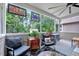 Cozy screened porch with comfortable seating and backyard view at 39 Westover Ct, Sanford, NC 27332