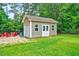 Backyard shed with garage door, perfect for storage and hobbies at 39 Westover Ct, Sanford, NC 27332