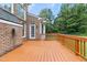 Expansive back deck provides ample outdoor living space with a brick home and verdant backyard at 402 Bridewell Ct, Cary, NC 27518