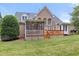 A brick home with a screened-in porch, wooden deck and manicured lawn at 402 Bridewell Ct, Cary, NC 27518