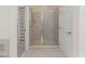 Bathroom featuring a glass enclosed shower, shelving and a tiled floor at 402 Bridewell Ct, Cary, NC 27518