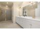 Primary bathroom boasts double vanity, large mirror, and glass shower at 402 Bridewell Ct, Cary, NC 27518