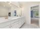 Bright bathroom featuring double vanity with gold fixtures and entrance to blue room at 402 Bridewell Ct, Cary, NC 27518