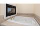 An opulent bathtub next to a cozy fireplace for ultimate relaxation at 402 Bridewell Ct, Cary, NC 27518