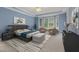 Relaxing bedroom featuring a tray ceiling, bay windows, sitting area and plush carpet at 402 Bridewell Ct, Cary, NC 27518