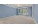 Spacious primary bedroom with tray ceilings, large windows and neutral carpet at 402 Bridewell Ct, Cary, NC 27518