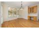 Dining area with hardwood floors, wainscoting, and natural light at 402 Bridewell Ct, Cary, NC 27518