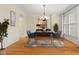 Elegant dining room with hardwood floors, crown molding, and a decorative chandelier over a set dining table at 402 Bridewell Ct, Cary, NC 27518