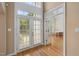 Inviting foyer with hardwood floors and grand front doors leading to an office at 402 Bridewell Ct, Cary, NC 27518