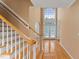 Grand foyer with hardwood floors, high ceilings, staircase, and large windows at 402 Bridewell Ct, Cary, NC 27518