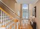 Grand foyer showcasing a staircase, hardwood floors, and a two-story window for ample natural light at 402 Bridewell Ct, Cary, NC 27518